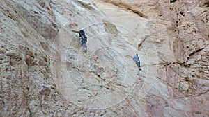 Alpinists in protective equipment climb mountain