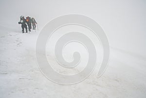 Alpinists and stormy weather photo