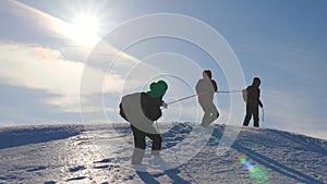 Alpinists team in winter down rope from the mountain. well-coordinated teamwork tourism in winter. Travelers descend by