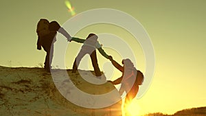 Team of climbers climbs a mountain holding out a helping hand to each other. Free woman traveler climb mountain photo