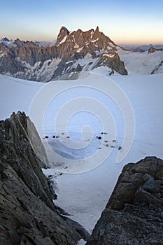 Alpinists tents on Col du Midi in front of Grandes Jorasses, Mont Blanc massif in the French Alps, Chamonix Mont-Blanc, France