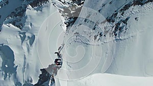 Alpinists on Top of Snow-Capped Mountain in Sunny Day. Aerial View. Vertical Video