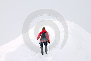 Alpinists trekking in harsh winter conditions in the Transylvanian Alps.