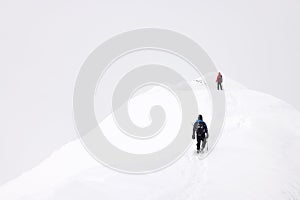 Alpinists trekking in harsh winter conditions in the Transylvanian Alps.