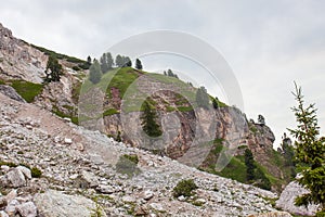 Alpinists walking on path upon Dibona section, an important geologic site of Tofana Mountain Group