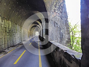 Alps Adria - Ciclovia Alpe Adria bike lane entering one of the many tunnels on the route, Val Canale valley, Udine