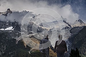 Alps chamonix couple of young people in love admiring the Bosson glacier Wildlife global warming glacier melting