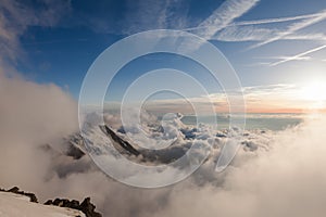 Alps in the clouds during sunset