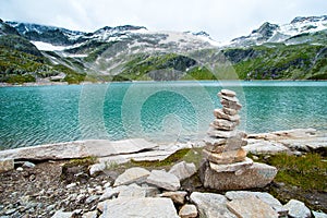 Alps landscape - glacial lake in front of mountains and blue sky