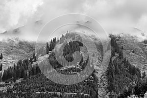 Alps mountains in clouds, black and white