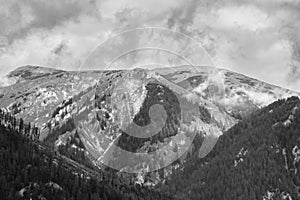 Alps mountains in clouds, black and white