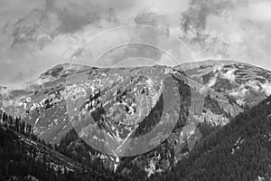 Alps mountains in clouds, black and white