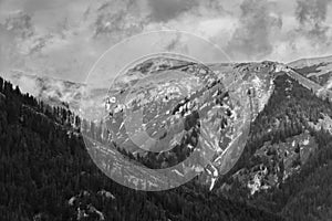 Alps mountains in clouds, black and white