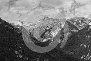 Alps mountains in clouds, black and white