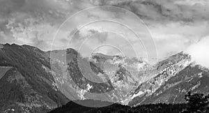 Alps mountains in clouds, black and white