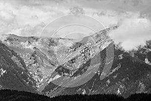 Alps mountains in clouds, black and white