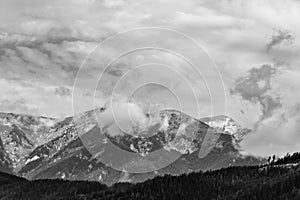 Alps mountains in clouds, black and white