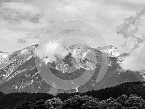 Alps mountains in clouds, black and white