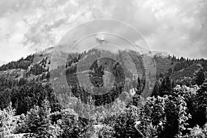 Alps mountains in clouds, black and white