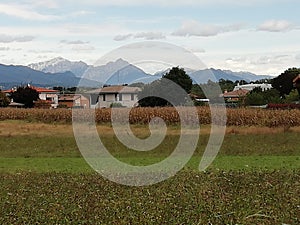 Alps and mountains in farmlands landscape  in italy photo