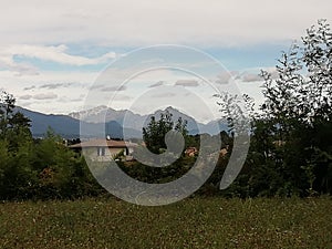 Alps and mountains in farmlands landscape  in italy