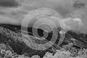 Alps mountains in clouds, black and white