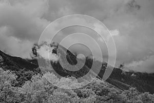 Alps mountains in clouds, black and white