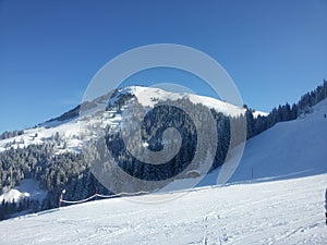 Alps skiing in Austria, winter mountains, snow and downhill course