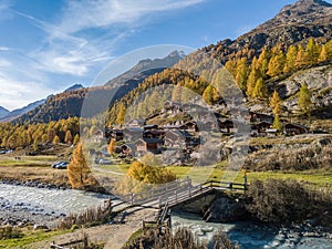 Alps village with tradtional wooden chalets in autumn photo