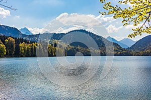 Alpsee im AllgÃ¤u with mountains and forests