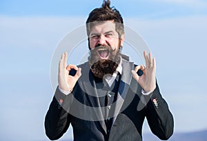 Alright gesturing. Man bearded optimistic businessman wear formal suit sky background. Success and luck. Optimistic mood