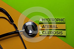 ALS. Amyotrophic Lateral Sclerosis acronym on sticky notes. Office desk background photo