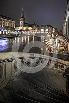 The Alsterfleet and the City hall in Hamburg at night. Beautiful illuminated downtown, city center