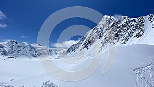 Altai mountains, blue sky and white clouds. Beautiful snowy mountain winter landscape. Climbing Mount Belukha