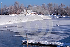 Altai russian country village Talitsa under winter snow on bank