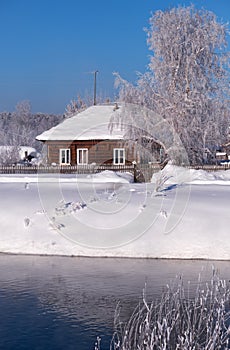 Altai russian country village Talitsa under winter snow on bank of river