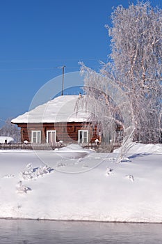 Altai russian country village Talitsa under winter snow on bank of river