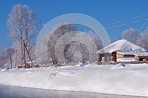 Altai russian country village Talitsa under winter snow on bank of river