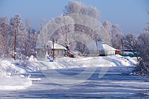 Altai russian country village Talitsa under winter snow on bank of river