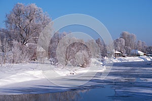 Altai russian country village Talitsa under winter snow on bank of river