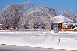 Altai russian country village Talitsa under winter snow on bank of river