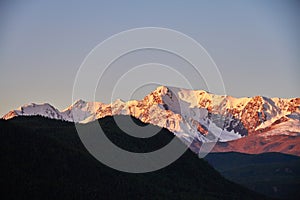 Altai, Snow-capped mountains at sunset. The evening sun shines on the mountains, autumn landscape Altay. Noise and blur