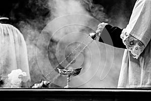 altar boy of the catholic church with thurible in his hand during a celebration