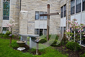 Altar Christian Presbyterian outside with cherry blossoms, wooden cross in church courtyard