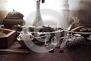 Altar for energetic cleansing and witch rituals with various bundles, stones and crystals photo