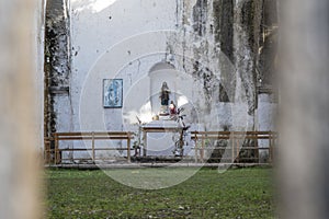 Altar and saints inside dilapidated church in Yaxunah, Mexico