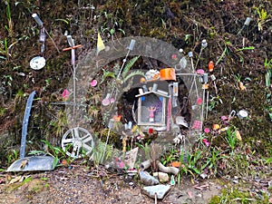 Altar to the Divino NiÃ±o, including rims, mufflers, and other vehicle parts. photo