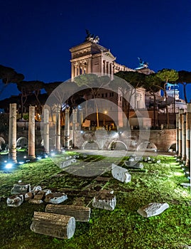 Vittorio Emanuele II monument at night, as seen from the Basilica Ulpia ruins, in Rome, Italy.