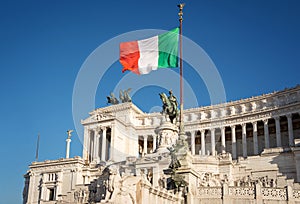 Altare della Patria in Rome and the flag of Italy with a beautiful blue sky