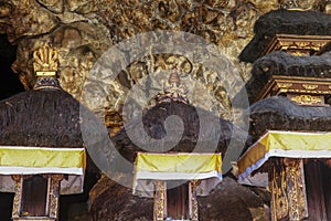Altars at Pura Goa Lawah or Bat Cave Temple. Balinese Hindu temple in Pesinggahan, Klungkung, Bali, Indonesia. Many bats hanging